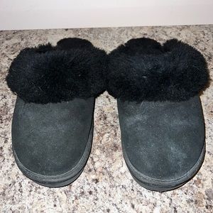 Black slip on shoes with soles.